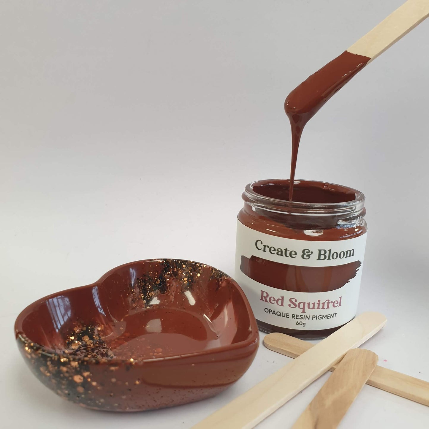 Red brown pigment on a stick with a resin paint pot and heart trinket dish make