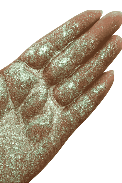 green interference glitter in hand, for resin crafts and mixed media