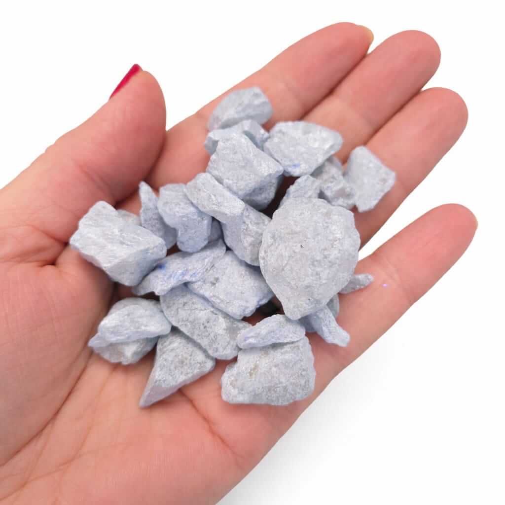 Baby blue stones in palm of hand, for mixed media crafting