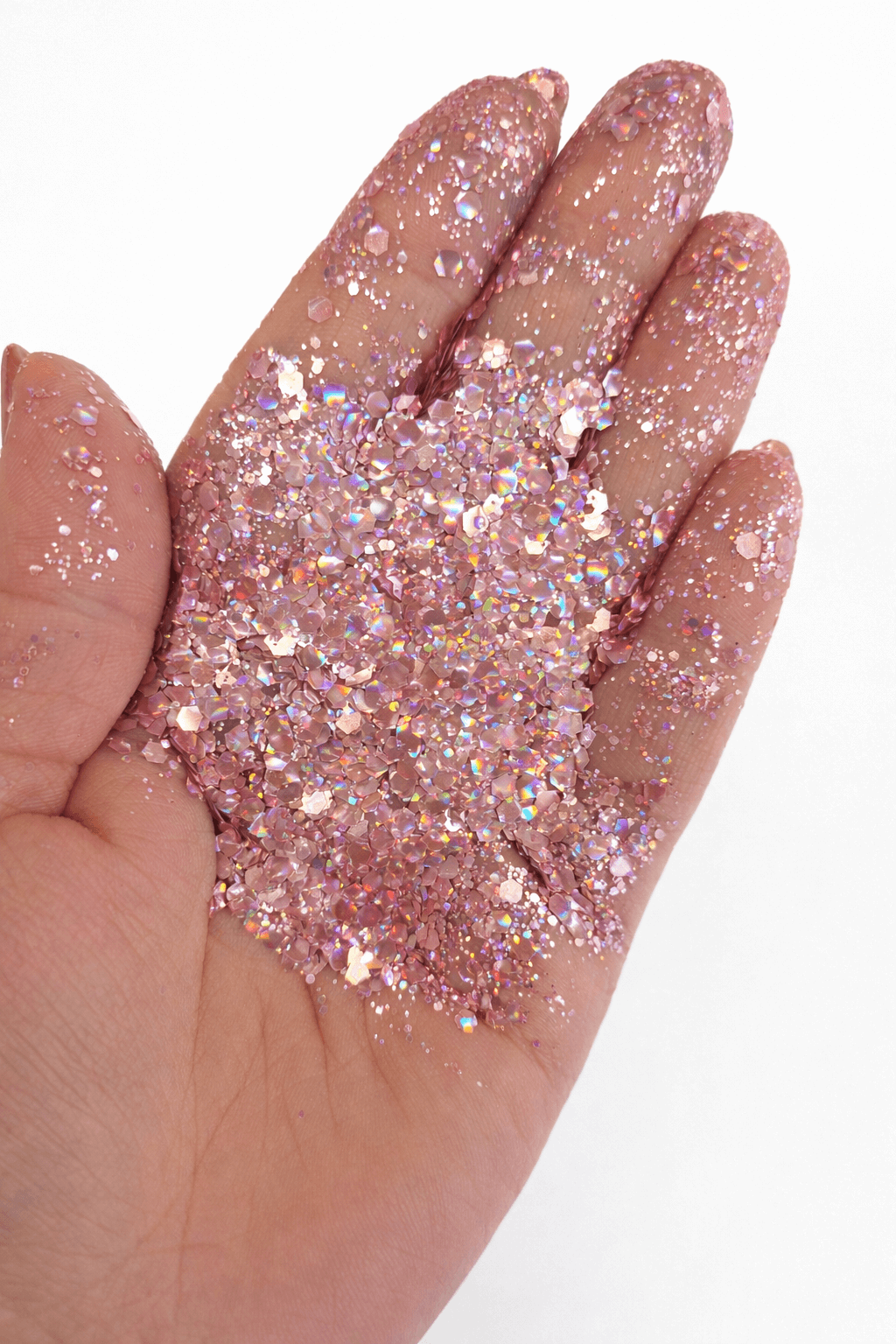 soft pink chunky hex glitter in palm of the hand
