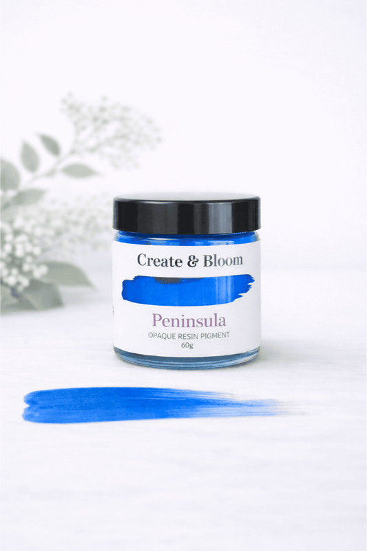 Jar of 'Peninsula' resin pigment by Create & Bloom on a white background with a blue color swatch.
