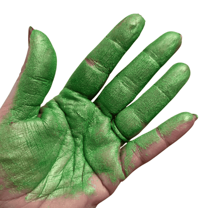 Hand with green mica pigment on a white background