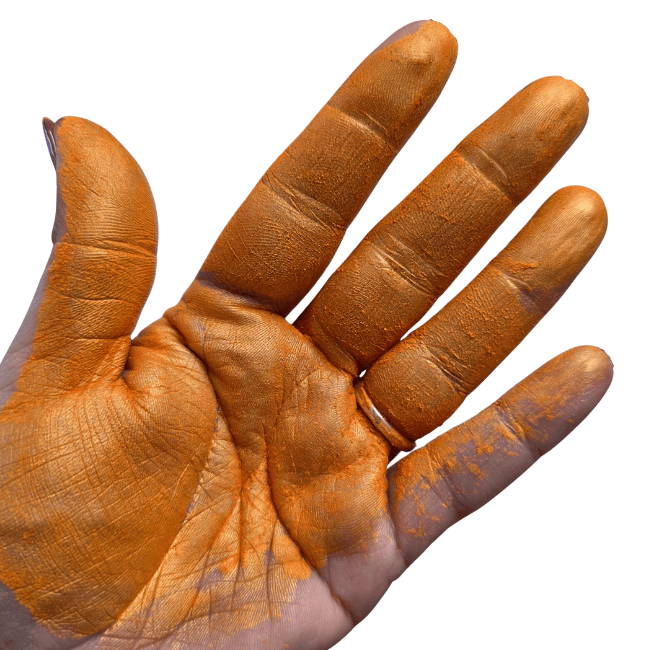 Orange pigment paint mica powder in palm of the hand