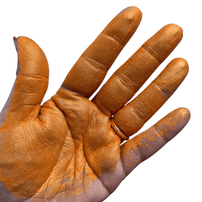 Orange pigment paint mica powder in palm of the hand