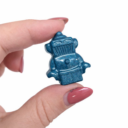 Blue mica pigment robot in hand