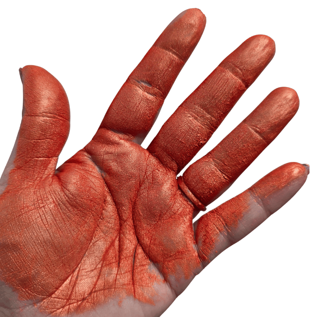 red mica pigment powder in hand