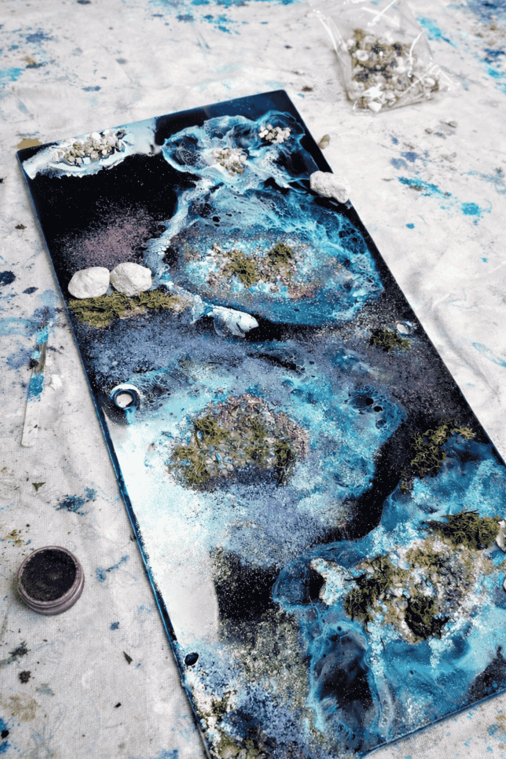 Abstract ocean resin art in progress showing layered sea textures, flow and movement using epoxy resin techniques - Create and Bloom and Apex resin products