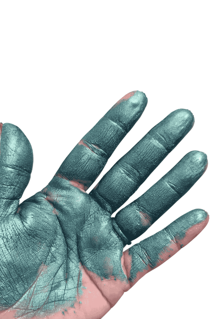 Hand with green Turquoise blue mica powder pigment on