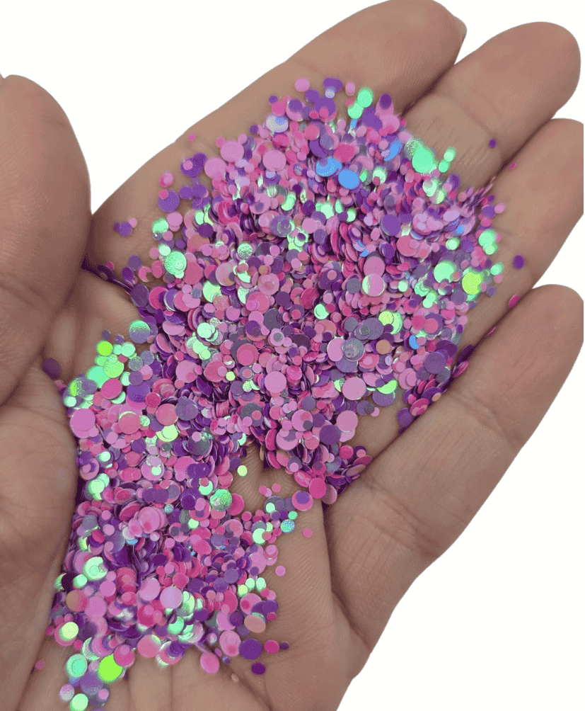 Mixed size dotty glitter in pink and purple tones with a subtle teal iridescent shift, shown in hand, perfect for resin and craft projects