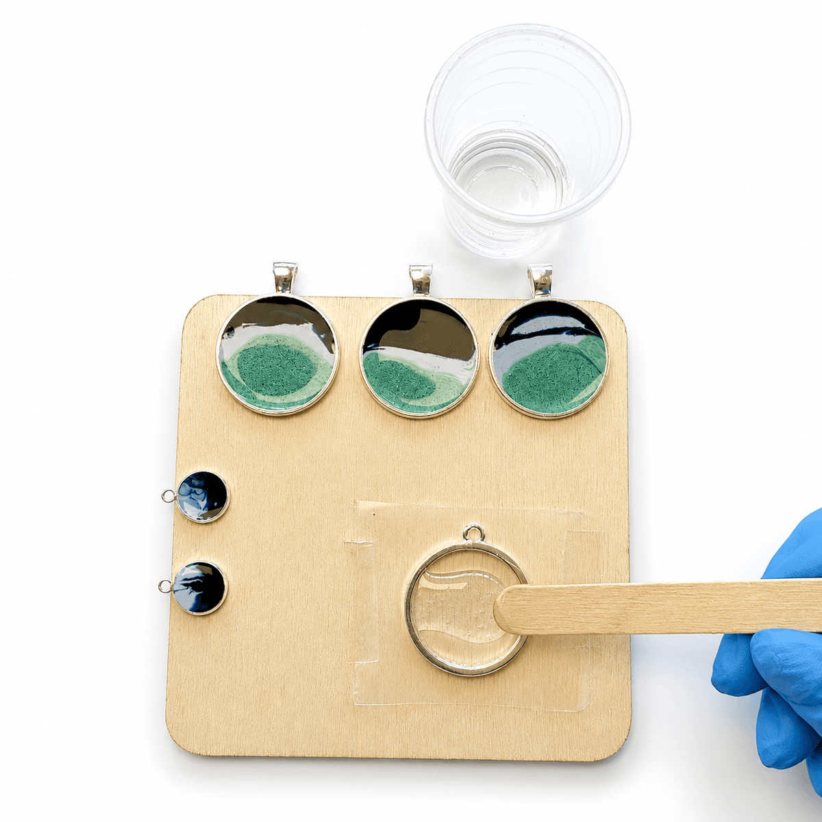 Adding clear epoxy resin to an open-backed ocean jewellery bezel