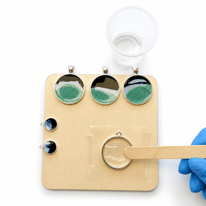 Adding clear epoxy resin to an open-backed ocean jewellery bezel